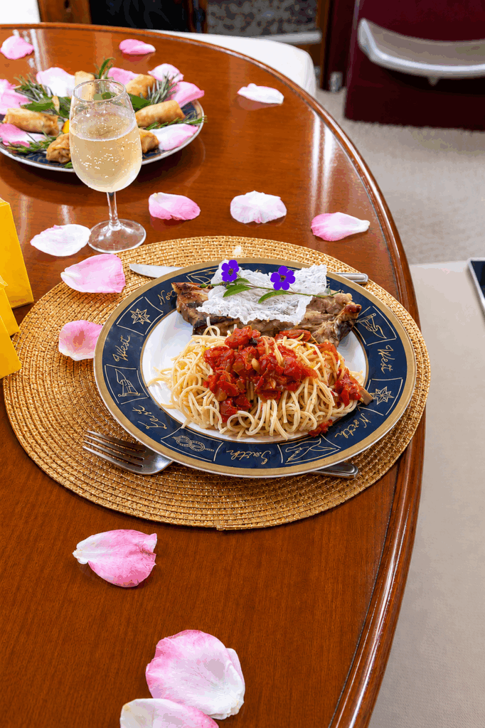 Romantic dining setup with rose petals on Sailing Edisa in Rhodes